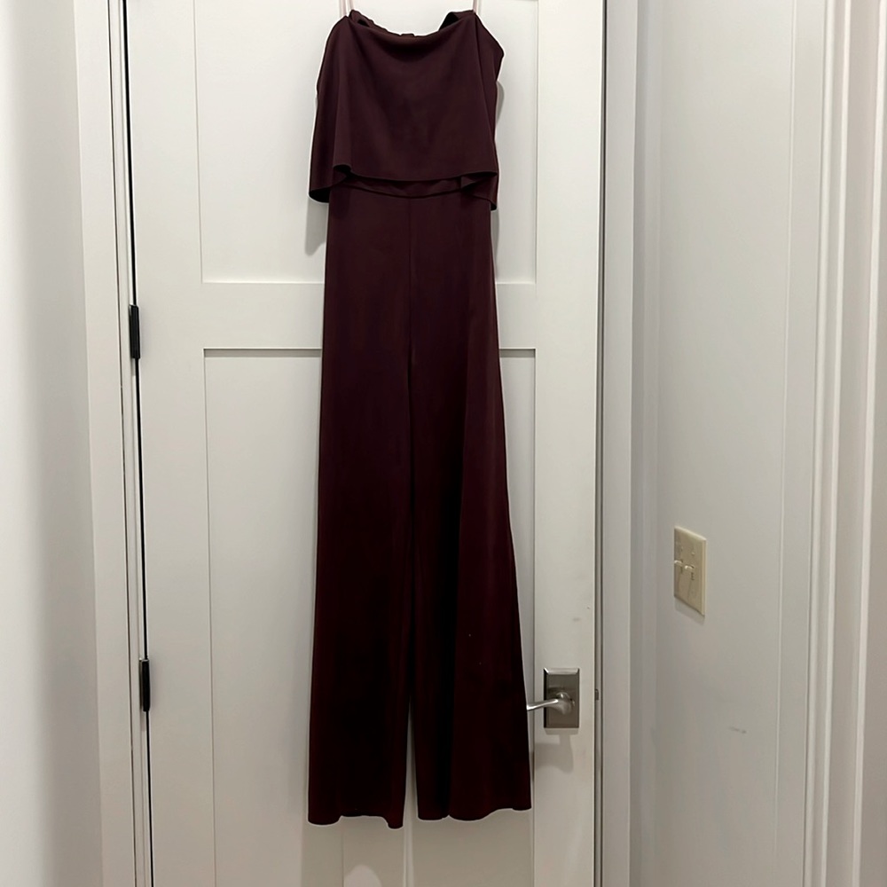 Women’s strapless burgundy suede jumpsuit.
